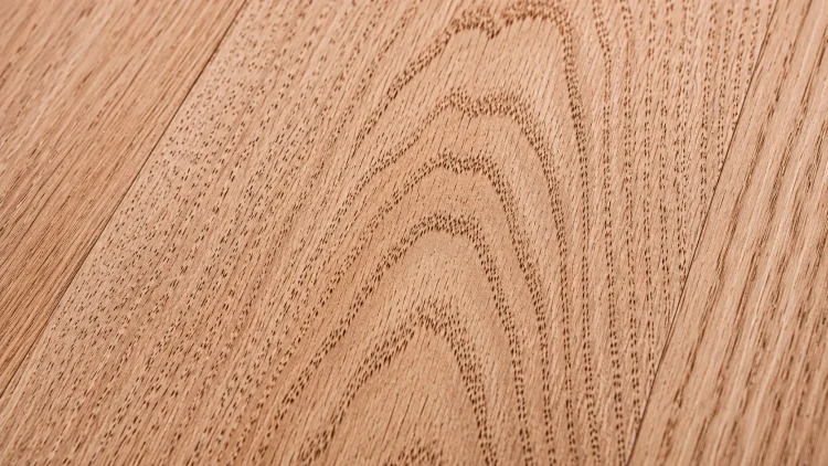 Close-up of red oak hardwood floor grain showing open pore structure before staining